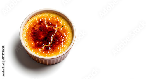 Creme brulee in ramekin isolated on white background with soft shadow and copy space, caramelized sugar crust
