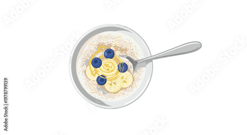 A nutritious bowl of warm oatmeal porridge topped with fresh blueberries sliced bananas and a golden drizzle of honey sits ready for a healthy breakfast.