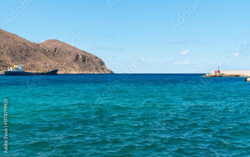 Wallpaper Mural Mediterranean Sea landscape from the seafront of Favignana Island, Province of Trapani, Sicily, Italy. Scenic coastal view featuring turquoise waters and rocky shoreline. Torontodigital.ca