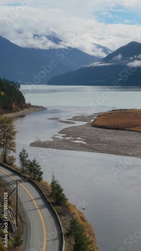 Winding Road Beside a Majestic Lake in the Cloud-Kissed Mountains of British Columbia, Canada