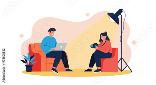 Creative photographer uses professional lighting to take a portrait of a man sitting on a sofa with his white laptop.