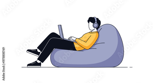 Young man wearing headphones and using a laptop while sitting comfortably on a soft bean bag chair against a white background.