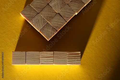 Many blank wooden cubes on yellow background, flat lay. Space for text