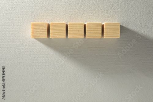 Blank wooden cubes on white background, flat lay. Space for text