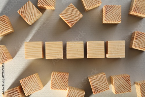 Many blank wooden cubes on white background, flat lay. Space for text