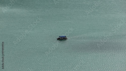 boat in the water lake bled slovenia (european travel tourism destination) castle island rent hire attraction beautiful julian alps clean water