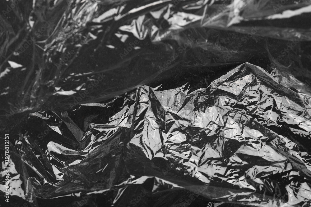 Naklejka premium Transparent plastic wrap on black background, closeup