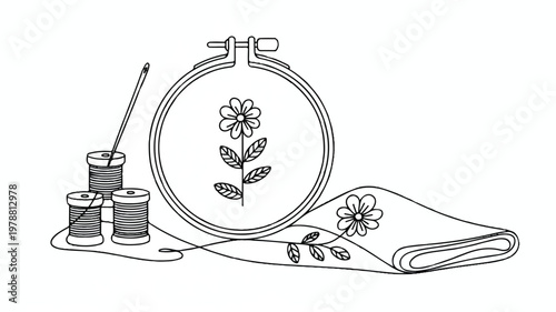 embroidery hoop with floral design and sewing supplies