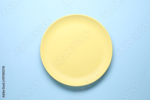 Konstfotografi Empty plate on light blue background, top view