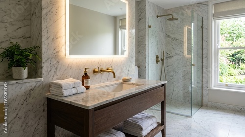 Elegant premium bathroom with marble and stone surfaces, featuring a sleek sink with a brass faucet, a large mirror with soft