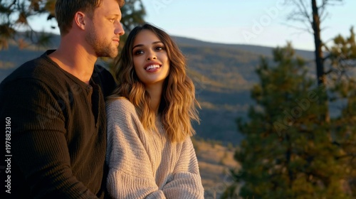 Couple Enjoys Sunset Together in Mountains While Sitting on Rocks During Autumn