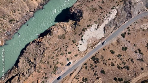 Aerial Birds Eye shot of the treacherous Hindustan-Tibet highway carved into the sheer vertical cliffs of a Himalayan gorge.