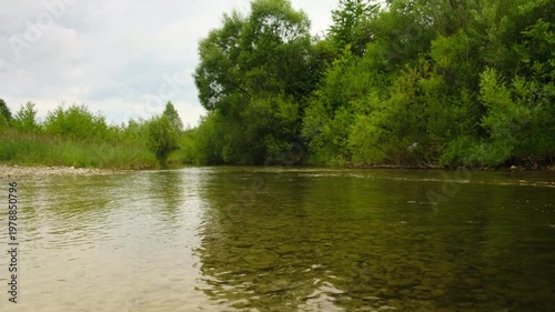 Beautiful river water with stone rapids and splashes at summer morning. Natural wonder, quiet place for green tourism concept. Background of fresh water with fast rapids in river