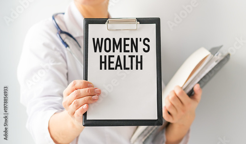 Medical professional holds clipboard labeled Women's Health. Gentle demeanor suggests care and professionalism.