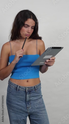 Creative designer pondering ideas and drawing on tablet