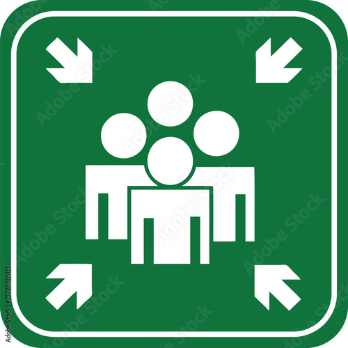 Green assembly point sign with white icons of people and arrows representing a safe meeting location for emergencies or evacuations
