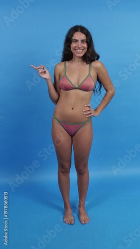 Surprised woman in bikini pointing finger