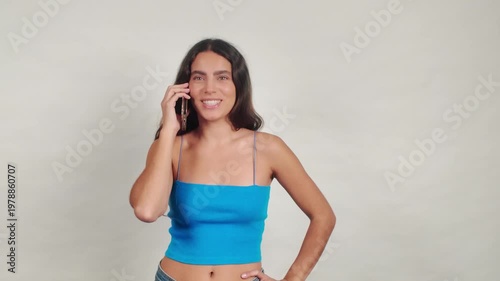 Young woman talking and laughing on smartphone call