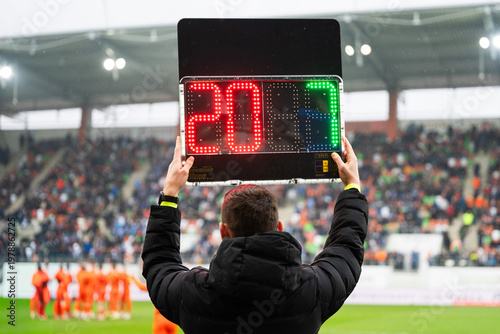 Obraz na płótnie Official holding a digital substitution board showing player numbers nine and seventeen during a professional football match at a stadium