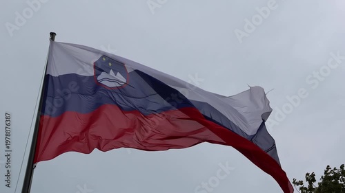 slovenia flag waving in the breeze wind at castle (lake bled) famous travel tourism destination in julian alps