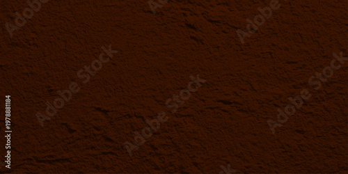 Natural brown coffee beans and dark chocolate texture create a vintage grunge backdrop with a rough aged stone pattern on a dark textured surface