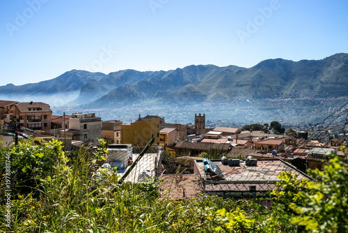 Scenic panoramic view of Palermo nestled against the Sicilian mountains on the northwestern coast, overlooking the Tyrrhenian Sea, capturing the dramatic landscape where urban architecture meets coast