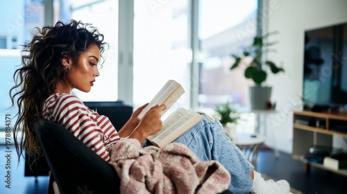 Young Woman Reading a Book in a Cozy Indoor Space With Plants in Sunlight