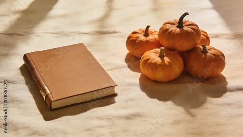 Cozy autumn reading with pumpkins and a classic leather-bound book