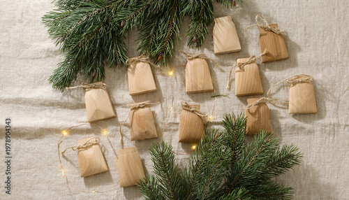 Minimalist Nordic advent calendar with wooden bags and pine branches