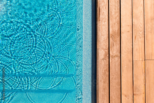 Bild auf Leinwand New modern fiberglass plastic swimming pool entrance step with clean fresh refreshing blue water on bright hot summer day at yard or resort hotel spa area