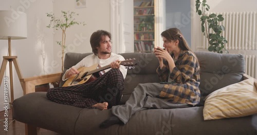 Friends enjoy a cheerful evening filled with music and laughter, creating unforgettable memories in a cozy living room