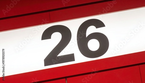 Close-up of the number 26 on a red background.