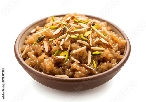 Traditional Eid dessert sheer khurma vermicelli pudding topped with slivered almonds pistachios served warm in terracotta brown bowl isolated on white background.