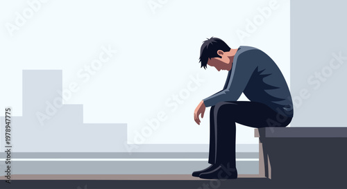 A man sitting alone feeling sad.