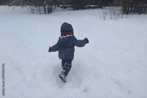 little boy playing in snow