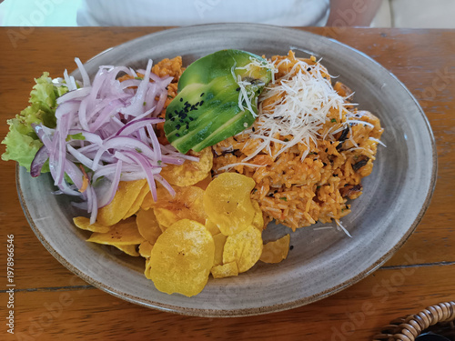 Peruvian arroz con mariscos seafood rice with avocado and plantain chips