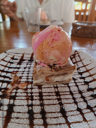 Dessert plate serving ice cream and cake with syrup