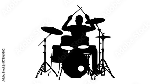Silhouette of a man playing a drum set energetically