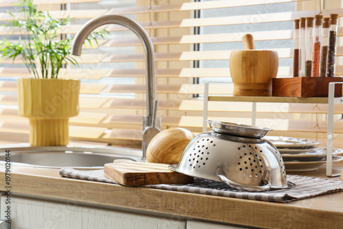 Metal colander with utensil...