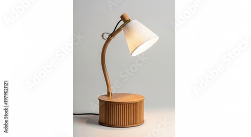 A minimalist table lamp casting a warm glow on a white surface