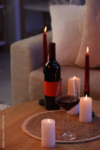 Red wine with burning candl...