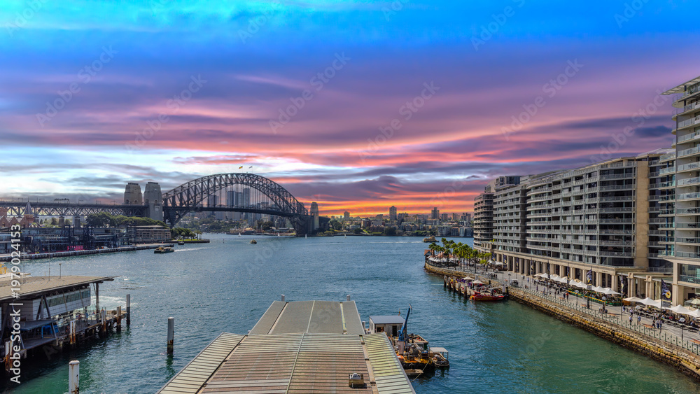 Obraz premium Title: View of Sydney Harbour and Circular Quay and Sydney Harbour Bridge in on beautiful Autumn Afternoon beautiful Sky Sydney NSW Australia