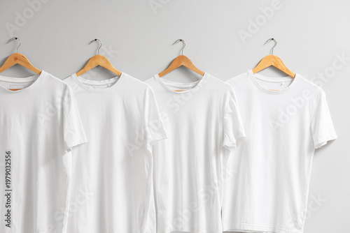 White t-shirts hanging on l...