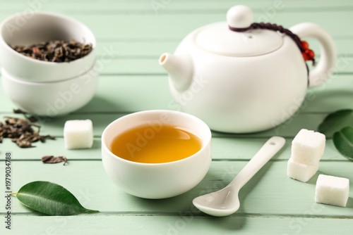 Teapot with cup of tea, dry...