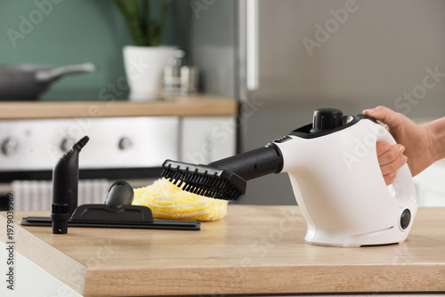 Female hand with steam clea...