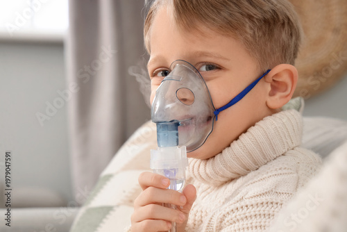 Cute little boy using nebul...