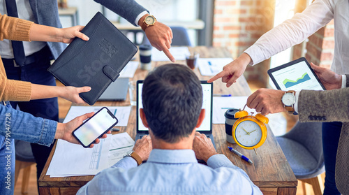 Tablou pe pânză Businessman at laptop facing immense pressure and demands, with multiple hands pointing and offering tasks and tools