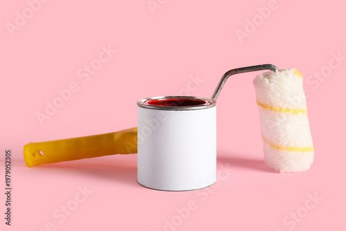 Can of red paint and roller...