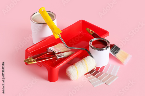 Cans of paint with roller, ...