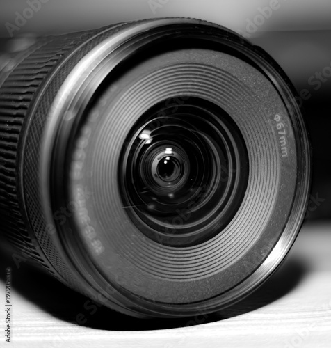 Obraz na plátne Close-up black and white macro shot of a modern wide-angle camera lens front element with 67mm filter thread